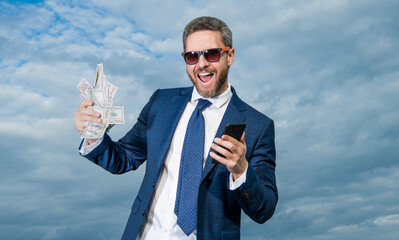 glad betting man with lottery money hold phone. photo of betting man with lottery money