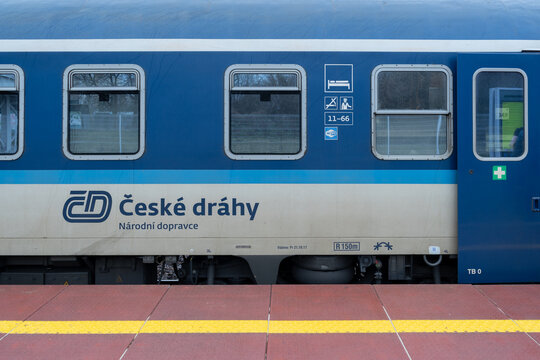 Česk&eacute; dr&aacute;hy passenger train at railway station platform. ČD railroad car, wagon, carriage or compartment coach. Ceske drahy Czech Railways long-distance express on March 24, 2023 in Warsaw, Poland.