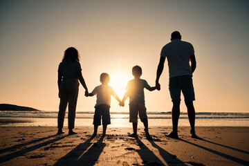 Family silhouette at the beach, holding hands at sunrise and people with love, care and support...