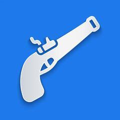 Paper cut Vintage pistol icon isolated on blue background. Ancient weapon. Paper art style. Vector