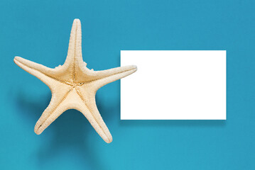 Flat lay composition with beautiful starfish on colored blue table. Vacation concept. Summer time concept. Top view, mockup, copy space for text.	