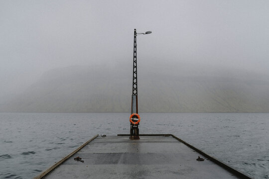 Wet jetty over foggy ocean, Kollafjorour, Faroe Islands
