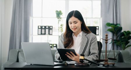 justice and law concept.Female judge in a courtroom on wooden table and Counselor or Female lawyer working in office.