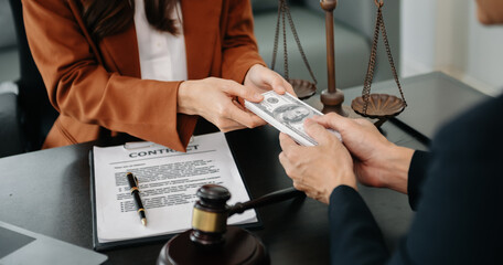 justice and law concept.passing bribe money in the envelop at lawyer office. businessman hand...