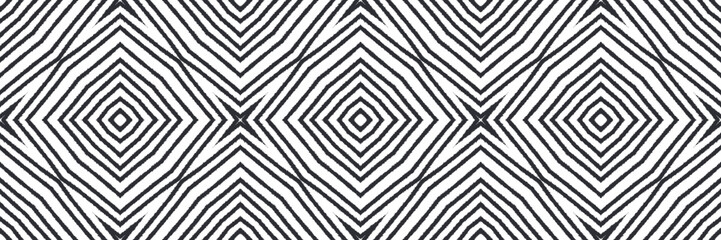 Ikat repeating seamless border. Black symmetrical kaleidoscope background. Summer ikat sweamwear pattern. optimal decorative design element for background.