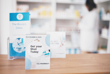Flu vaccine, sign and pharmacy poster in a medical shop and clinic for healthcare. Wellness, doctor and covid booster shot advertising placard showing health message for customer on a paper billboard