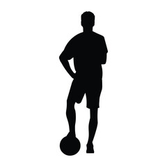 Professional football player silhouette stands straight with his foot on the ball and his arms folded on his chest