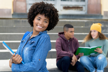 Young african american female student with group of hispanic young adults