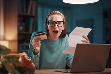 Desperate woman checking an expensive invoice