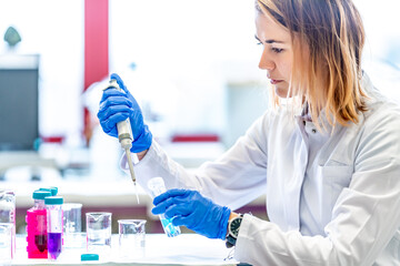 mixing of chemical substances by a young female scientist in a university research laboratory....