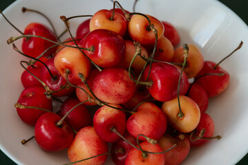 Fresh ripe cherries in a white plate. Close-up. Vegetarian breakfast. Healthy food.