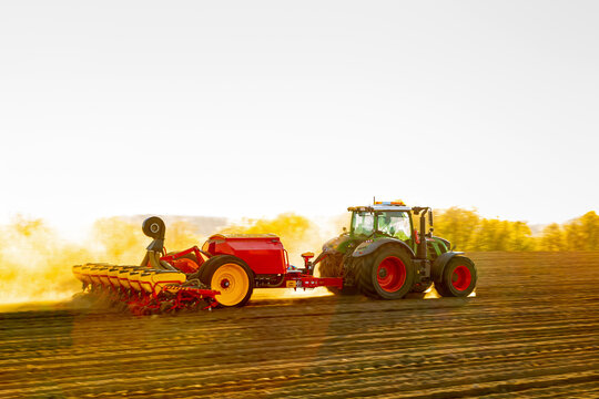 Tractor plowing field at spring