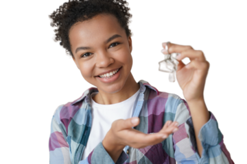 Smiling young biracial girl houseowner tenant holds house key to new home. Real estate service