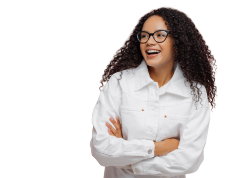 Carefree cheerful Afro American woman wears white jacket, keeps arm folded, looks aside, has charming smile, enjoys nice day in company of friends, stands against pink wall with empty space left