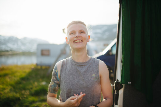 Smiling woman standing at camping site