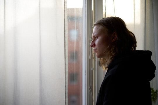 View of man looking through window