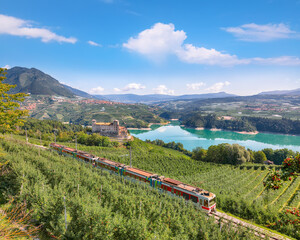 Obraz na płótnie Canvas Fabulous View of the Cles Castel, the Santa Giustina Lake and lots of apple plantations.