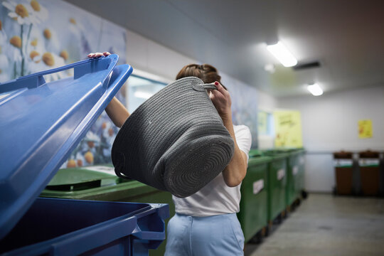 Woman putting waste in recycling bins