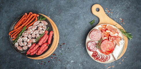 delicious salami, pieces of sliced prosciutto crudo, sausage and wine. Meat platter. Mixed delicatessen of meat snacks. place for text, top view