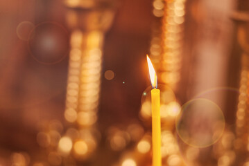 Candle burning in golden church background. Card with Copy Space for text.