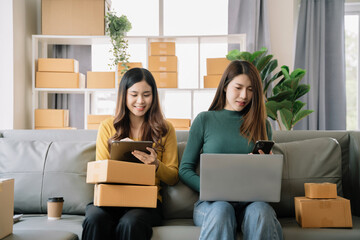 Small business woman Worker delivery service and working packing box, business owner working checking order to confirm before sending customer in post office.