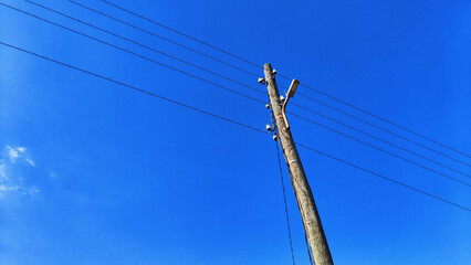 Power line pole on a blue sky background