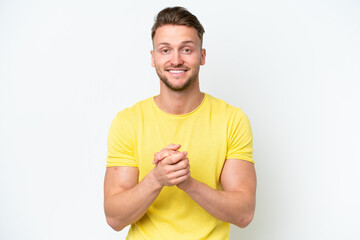 Young blonde caucasian man isolated on white background laughing