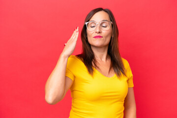 Fototapeta premium Middle-aged caucasian woman isolated on red background with tired and sick expression