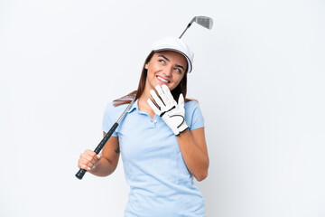 Young caucasian woman playing golf isolated on white background looking up while smiling