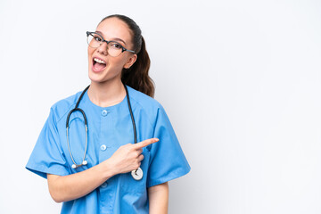 Young caucasian surgeon doctor woman isolated on white background surprised and pointing side