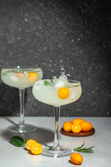 Iced kumquat cocktail with ice. Freeze motion splash drops of refreshing soda. top view. place for text