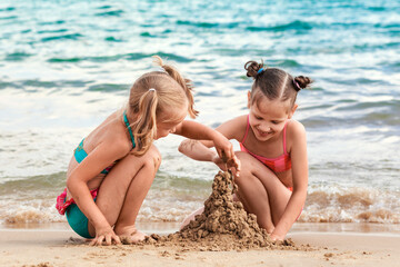 Sea Summer Fun Vacation. Happy Children building Sand castle, Playing on Sea Beach. Sandy Beach for Kids. 