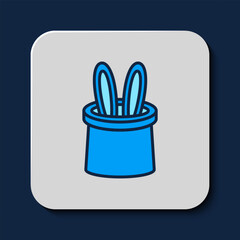 Filled outline Magician hat and rabbit ears icon isolated on blue background. Magic trick. Mystery entertainment concept. Vector