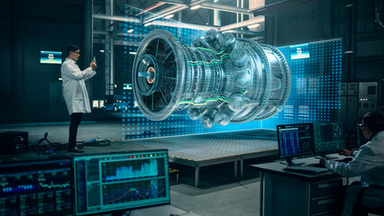 Factory: Engineer Holds Tablet Computer, Designes Engine in Augmented Reality App. Industry 4.0 Concept: Research, Development, Visualization, Digitalization of Powerful Green Energy © Gorodenkoff