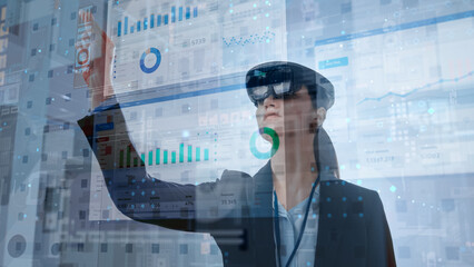 Young Female Using Futuristic Augmented Reality Software Interface for Managing Business and...