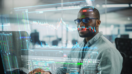 Futuristic Office with Hologram Screens Concept: Portrait of Professional Black IT Specialist Working on Desktop PC with Holographic Projection Showing Stock Market Information, Big Data, Charts