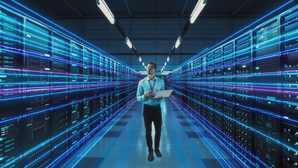 Futuristic Concept: Data Center Chief Technology Officer Holding Laptop, Standing In Warehouse,...