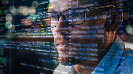Portrait of Startup Digital Entrepreneur Working on Computer, Line of Code Projected on His Face and Reflecting in Glasses. Developer Working on Innovative e-Commerce App using AI and Big Data.