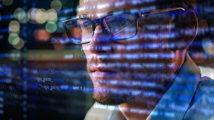 Portrait of Startup Digital Entrepreneur Working on Computer, Line of Code Projected on Face and Reflecting in His Glasses. Developer Working on Innovative e-Commerce App using AI and Big Data