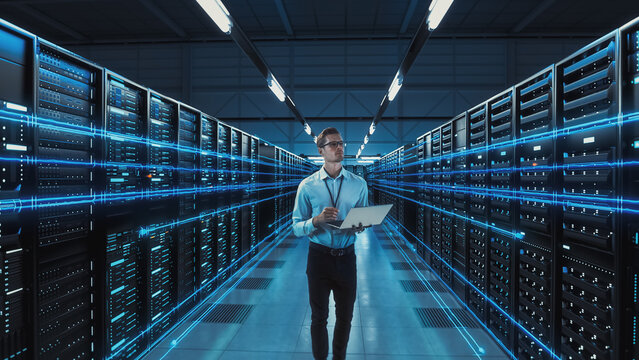 Futuristic 3D Concept: Big Data Center Chief Technology Officer Using Laptop Standing In Warehouse, Information Digitalization Lines Streaming Through Servers. SAAS, Cloud Computing, Web Service