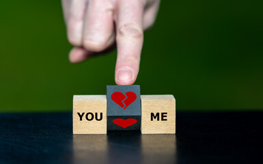 Symbol for breaking up a relation. Hand turns wooden cube and changes a heart symbol to a broken...