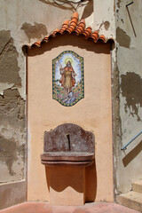 A street tap for drinking water decorated with a fresco.