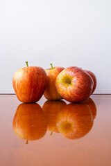 Four fresh red apples on a white background.