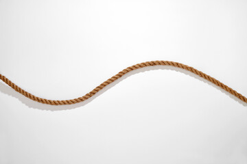 Natural fiber wavy rope with shadow on white background