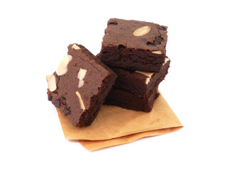 Brownies on paper isolated white background. Chocolate brownie with sliced almond nuts toppings. Chocolate Brownie pieces. selective focus.
