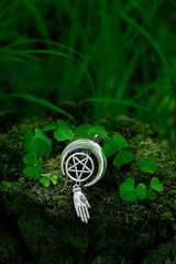 amulet with pentagram on abstract natural dark forest background. spiritual ritual. witchcraft,...
