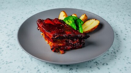 Closeup shot of a gourmet dish with steak, potatoes and sauce on a table