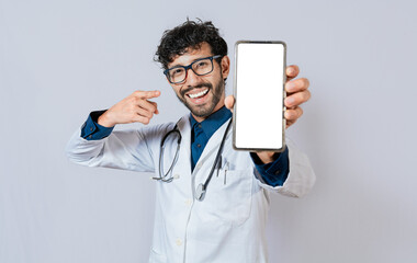 Happy doctor showing cell phone screen to camera. Smiling doctor showing cell phone screen pointing...