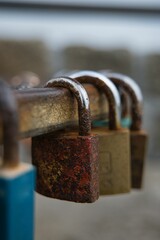 three rusted padlocks