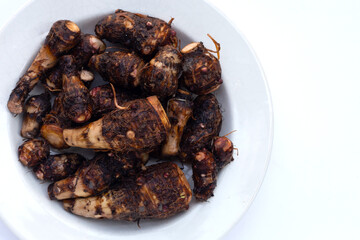 Organic taro fruit on white background.